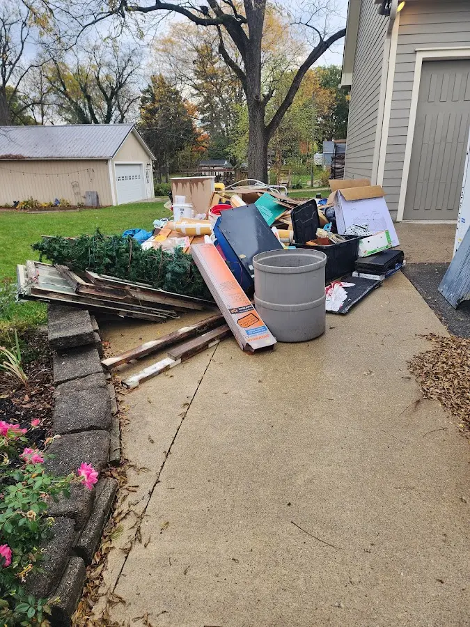 Dumpster being loaded with debris for Roofing Dumpster Rental in DeFuniak Springs